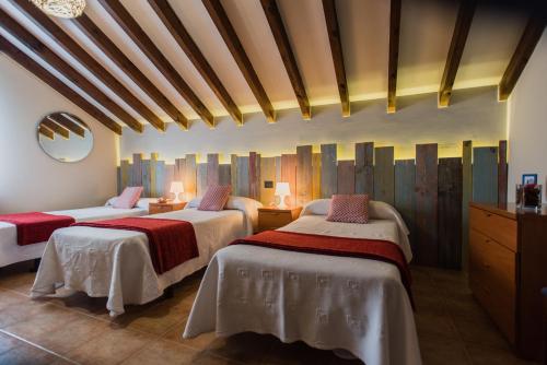 a bedroom with two beds with red and white sheets at Apartamentos River Santander in Santander