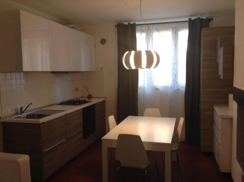 a kitchen with a sink and a table with a table at Appartamenti Villa Abbraccio in Siena