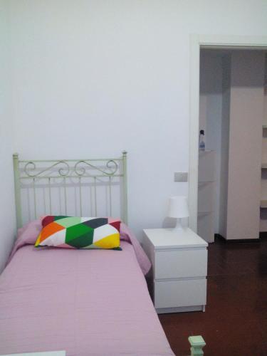 a bedroom with a bed with a pillow and a nightstand at Appartamenti Villa Abbraccio in Siena