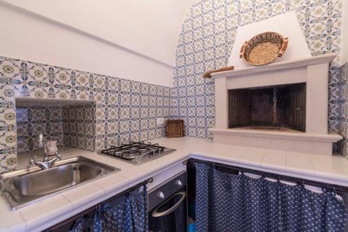 a kitchen with a sink and a stove at Trulli La Zisa in Fasano