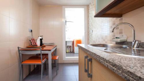 a kitchen with a sink and a counter at Apartamento Paseo del Golf in Roquetas de Mar