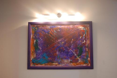 a painting on a wall with lights on it at Apartamentos La Harinera in Torres de Albarracín