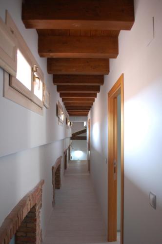a hallway with wooden ceilings and a long corridor at Apartamentos La Harinera in Torres de Albarracín