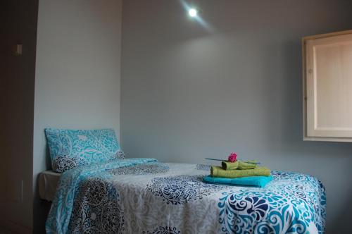 a bedroom with a bed with a stuffed animal on it at Apartamentos La Harinera in Torres de Albarracín