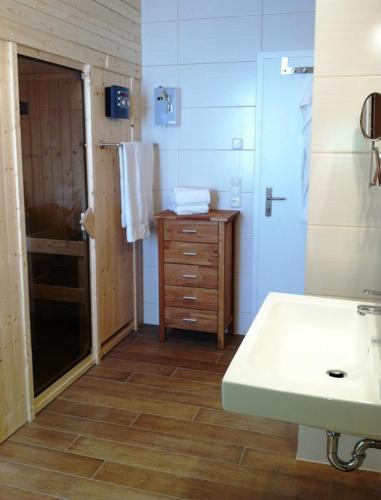 a bathroom with a sink and a cabinet and a mirror at Haus Hafenecke in Freest