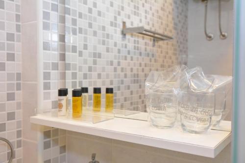a shelf in a bathroom with glasses on it at Apartment and room Sveti Jakov in Dubrovnik