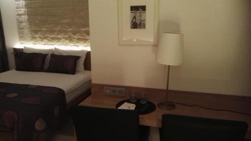a bedroom with a bed and a table with a lamp at House Novalia in Novalja