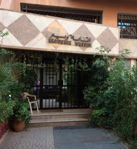 a entrance to a building with a sign on it at Appartement Wassim - Gueliz in Marrakech