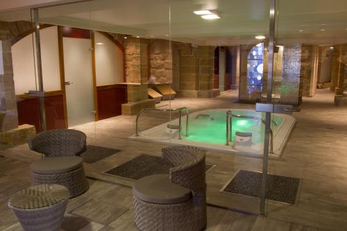 a bathroom with a jacuzzi tub in a building at Mercure Moulins Centre Hôtel de Paris in Moulins