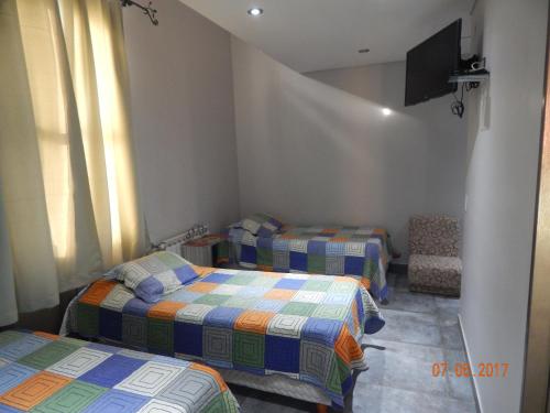 Ένα ή περισσότερα κρεβάτια σε δωμάτιο στο Hotel El Recreo