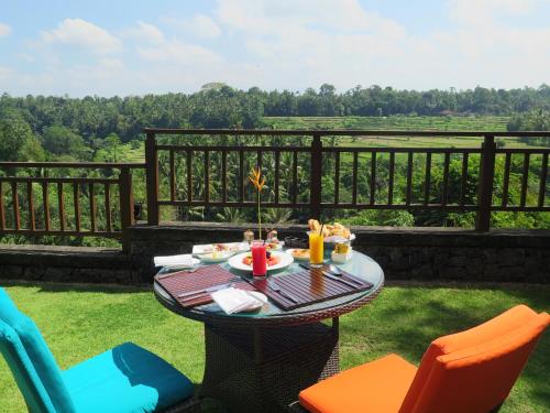 a table with food and chairs on a patio at The Samaya Ubud in Ubud