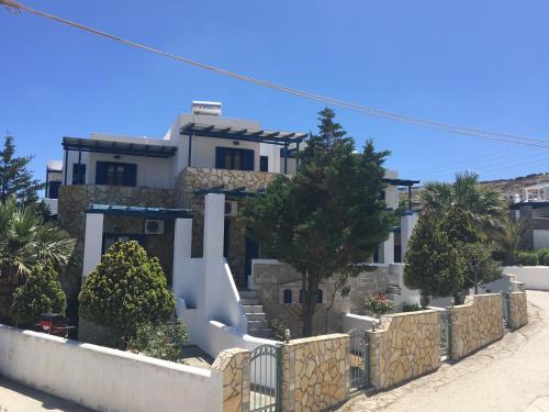 a house with a fence in front of it at Serifos Palace in Livadakia