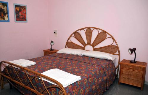 a bedroom with a bed and two night stands at Agriturismo Zinedi in Pantelleria