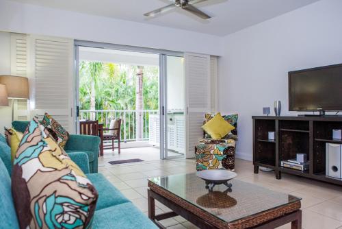a living room with a couch and a tv at 6424 BEACH CLUB in Palm Cove