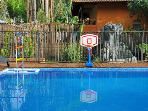 a pool with a sign in front of a fence at Love & Lemons in Yesod Hamaala