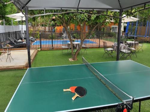 a man laying on top of a ping pong table at Love & Lemons in Yesod Hamaala