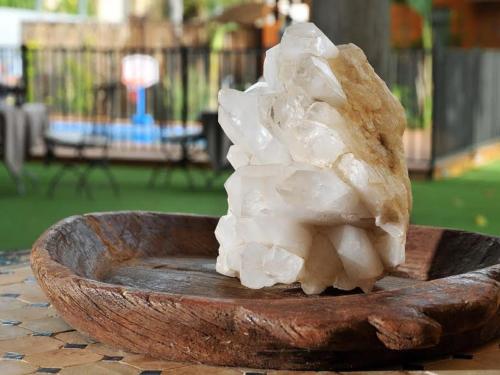 a pile of crystals in a wooden bowl on a table at Love & Lemons in Yesod Hamaala