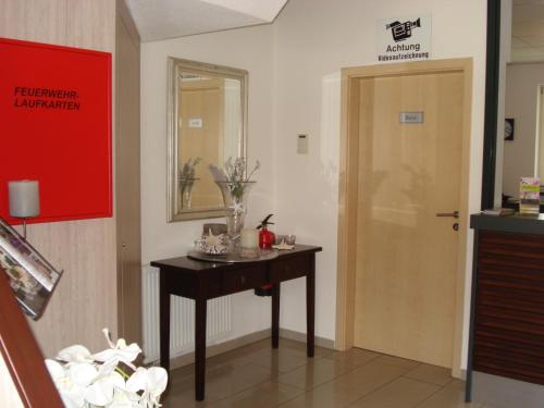 a room with a small table and a door at Hotel Restaurant Fritz in Gronau