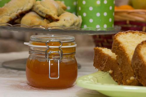 a jar of honey next to a plate of bread at Masseria Poli Country House in Conversano