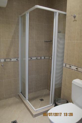 a shower with a glass door in a bathroom at Black Sea Apartment in Nesebar
