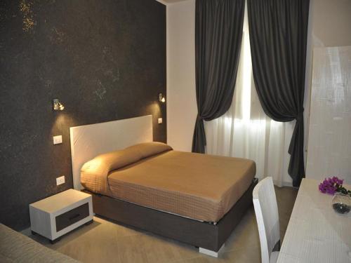 a bedroom with a bed and a tv in it at B&B Il Sole in Castelluzzo