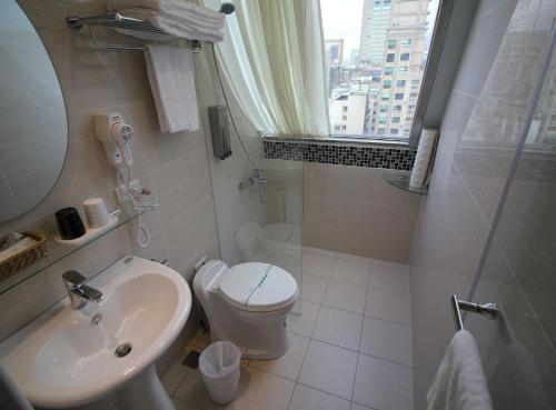 a bathroom with a sink and a toilet and a window at I Play Inn TP in Taipei