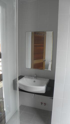 a white bathroom with a sink and a mirror at Neo Condo by Jean in Jomtien Beach