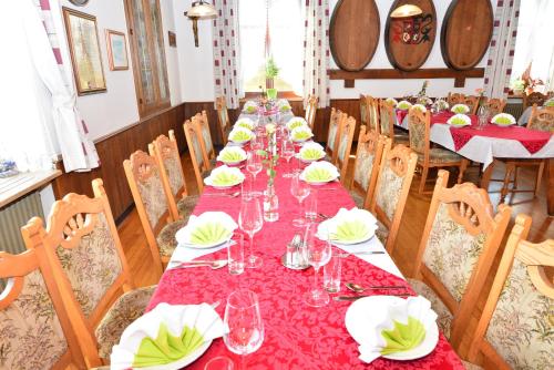 a long table with wine glasses and plates on it at Gasthof Wagner Restaurant-Pension in Halbenrain