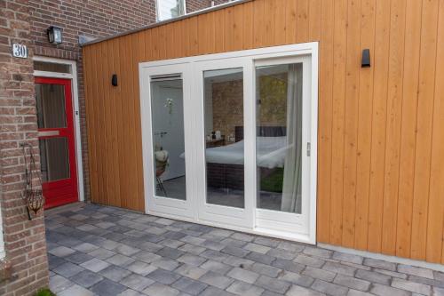 a white door on a building with a patio at In het Assendorpje in Zwolle