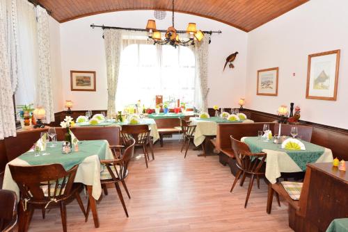 a dining room with tables and chairs and a window at Gasthof Wagner Restaurant-Pension in Halbenrain
