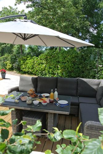 a table with food on it under an umbrella at B&B Veers Buuten in Veere