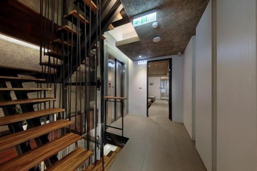 a hallway of a house with a staircase and a room at Laurel Villa B&B in Yuchi