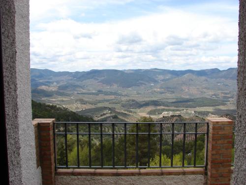 a view of a valley from a balcony at Apartamentos Sierra de Segura in Segura de la Sierra