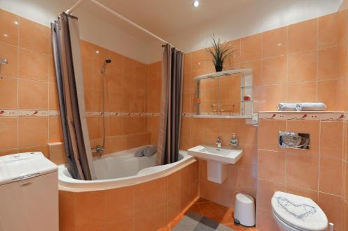 a bathroom with a sink and a shower and a toilet at Exclusive apartment on Zborovska in Prague