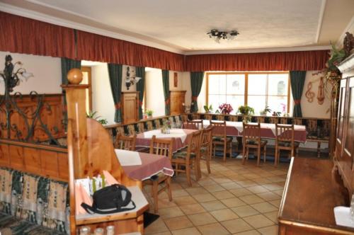 a restaurant with tables and chairs in a room at Gasthof Kirchenwirt in Zederhaus