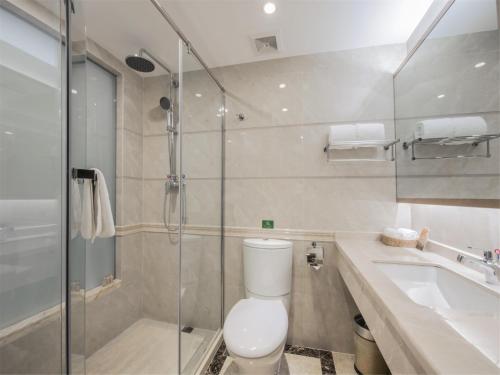 a bathroom with a toilet and a shower and a sink at Guangzhou Zhuhai Special Economic Zone Hotel in Guangzhou