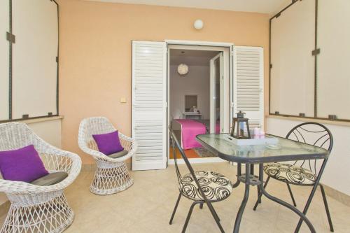 a dining room with a table and two chairs at Apartments Roso - ZF Hvar in Hvar