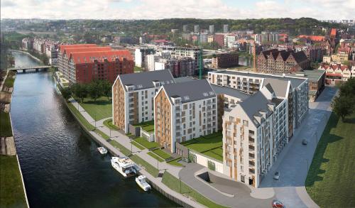 an aerial view of a city with a river and buildings at GRANO APARTMENTS Gdańsk Motława SPA & Wellness in Gdańsk