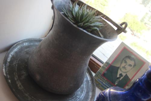 a vase with a plant in it next to a picture at CTH-Baku-Hostel in Baku