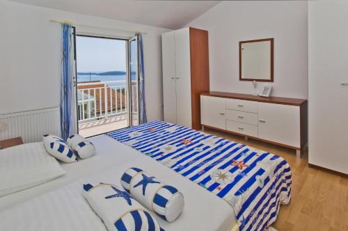 a bedroom with a bed with a view of the ocean at Apartments Roso - ZF Hvar in Hvar