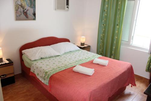 a bedroom with a bed with two towels on it at Guest House Dada in Dubrovnik