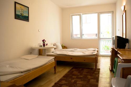 a room with two beds and a window at Hotel Romantic in Byala