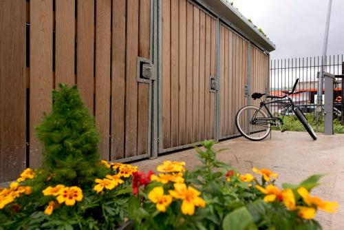 a bike parked next to a building with flowers at YHA Liverpool Albert Dock in Liverpool