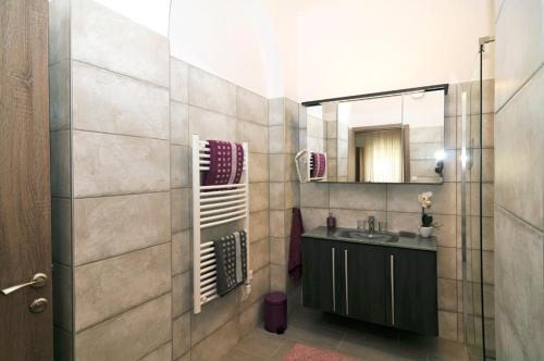 a bathroom with a sink and a mirror at Silver Beach Apartments in Siófok