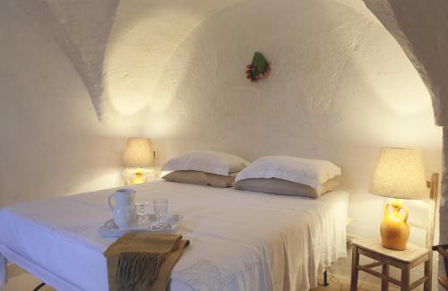 Säng eller sängar i ett rum på Masseria Eccellenza