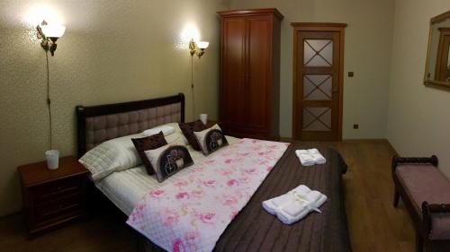 a bedroom with a bed with two towels on it at Apartment on Franka in Lviv