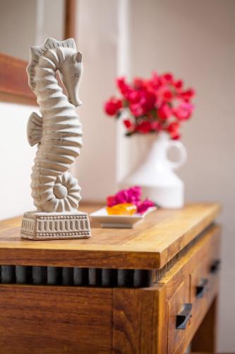 a statue of a seahorse on a table with flowers at Hotel Abatis in Skala