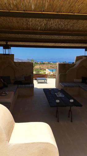 a patio with a table and a view of the desert at Il Baglio sull'Acqua in Favignana