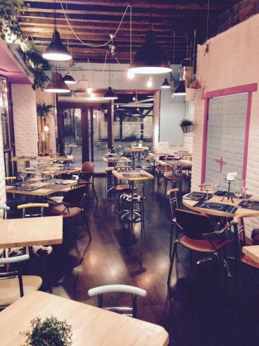 a dining room with tables and chairs in a restaurant at Hostal Alcántara in Avila