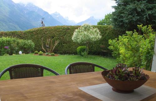 a wooden table with a bowl of plants on it at Landhaus Kirchmair in Telfes im Stubai